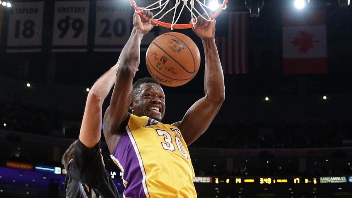 The Los Angeles Lakers’ Julius Randle dunked against the Minnesota Timberwolves’ Nemanja Bjelica during the first half Wednesday, Oct. 28, 2015, in Los Angeles.