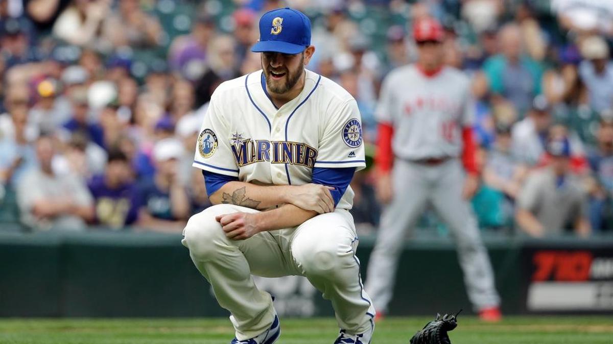 Seattle Mariners starting pitcher James Paxton holds his left arm after being hit by a line drive against the Los Angeles Angels in the ninth inning of a baseball game Sunday, Aug. 7, 2016, in Seattle. Paxton left the game.