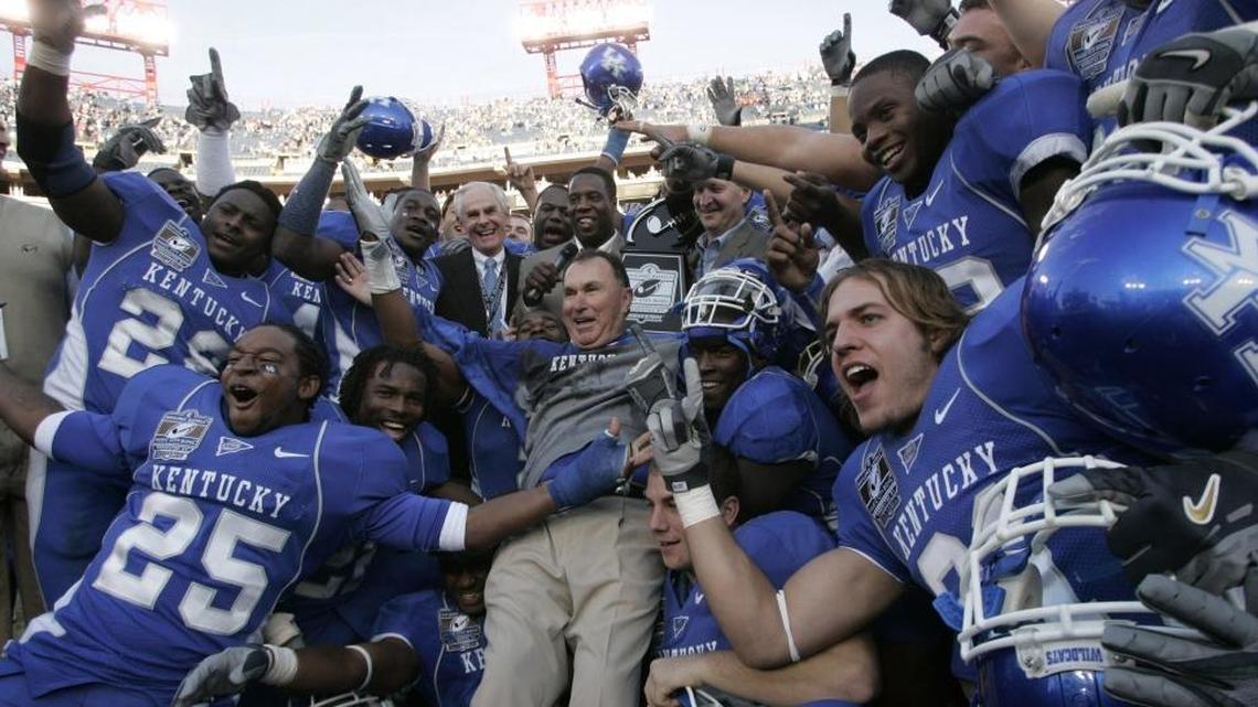 UK head coach Rich Brooks jumped into a pile of his players after they were presented their trophy after beating Clemson University 28-20 in the Music City Bowl at LP Field in Nashville, Tn., on Dec. 29, 2006.