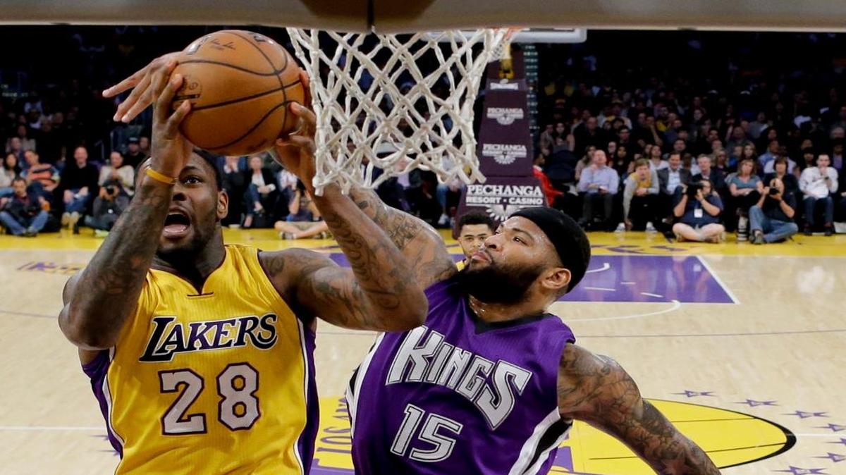 Sacramento Kings center DeMarcus Cousins, right, blocks a shot by Los Angeles Lakers center Tarik Black during the first half of an NBA basketball game in Los Angeles, Tuesday, March 15, 2016.