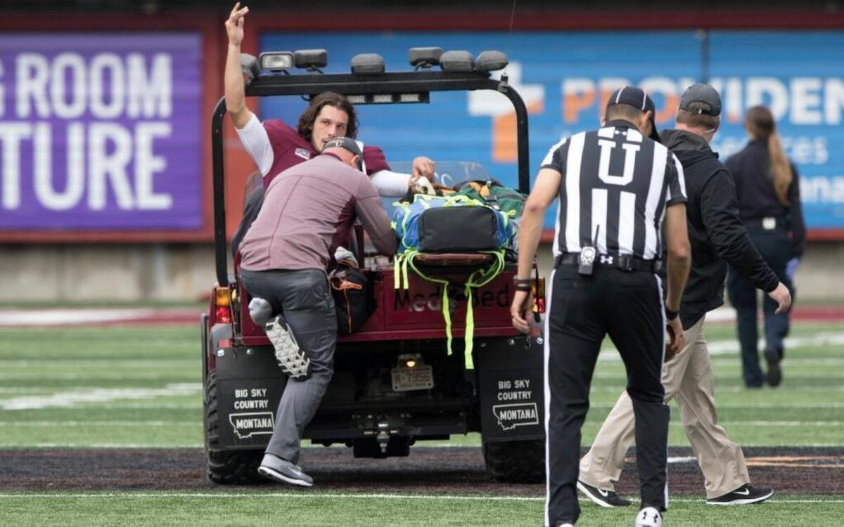 Montana quarterback Reese Phillips (11) acknowledges the crowd as he is being taken off the field on a cart after an injury against Savannah State in an NCAA college football game Saturday, Sept. 16, 2017, in Missoula, Mont.