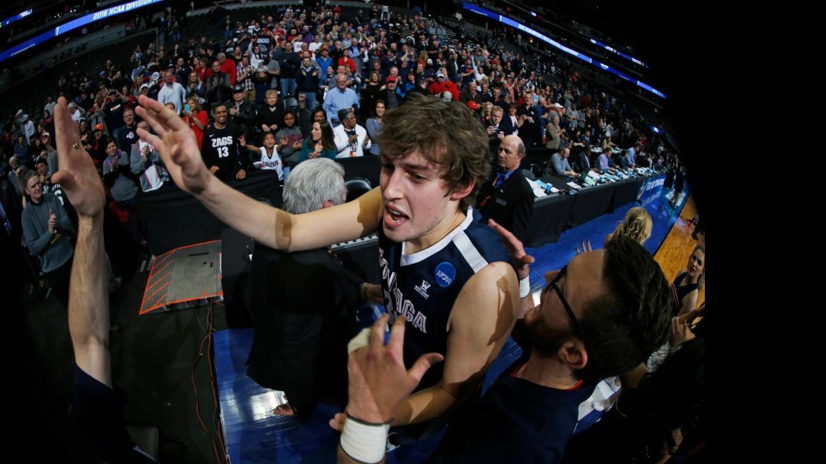 Gonzaga forward Kyle Wiltjer is congratulated as he leaves the court after Gonzaga defeated Utah 82-59 Saturday, March 19, 2016, in the second round of the NCAA men's college basketball tournament in Denver.
