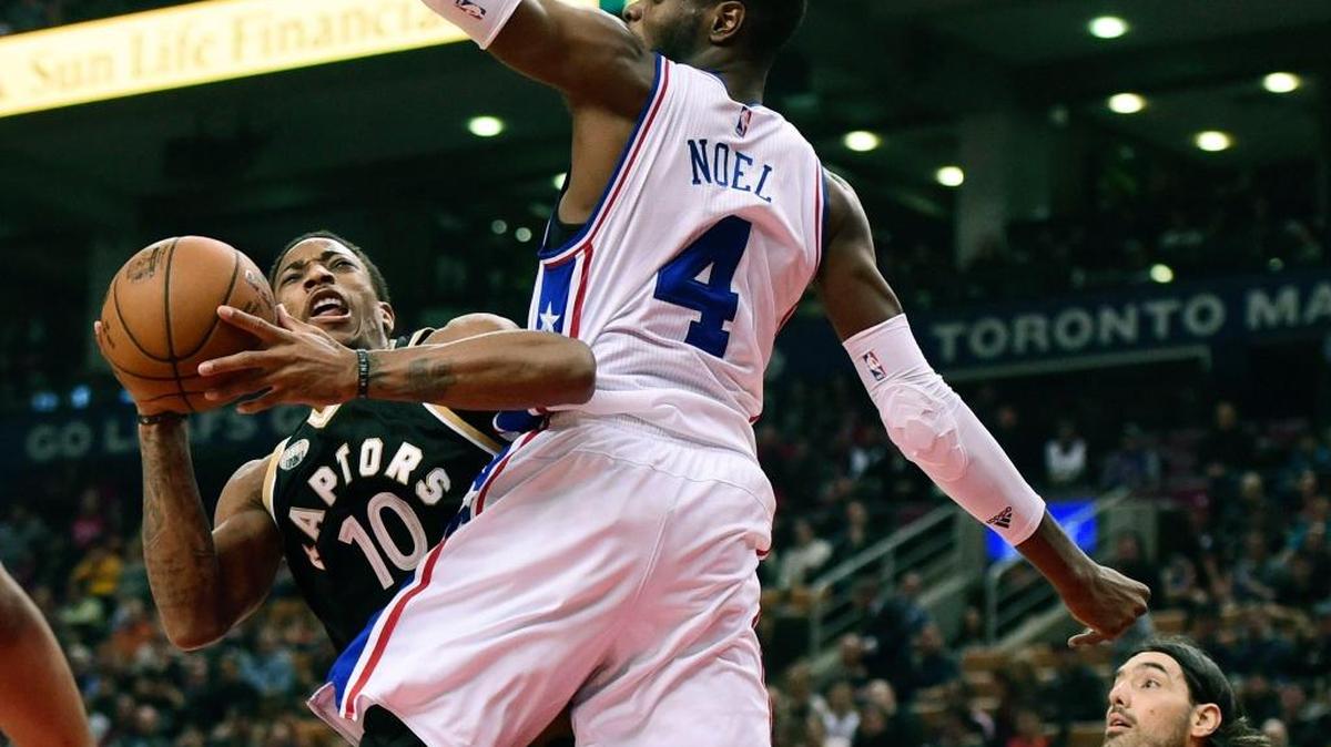The Toronto Raptors’ DeMar DeRozan, left, collided with the Philadelphia 76ers’ Nerlens Noel while driving to the basket during first half Sunday