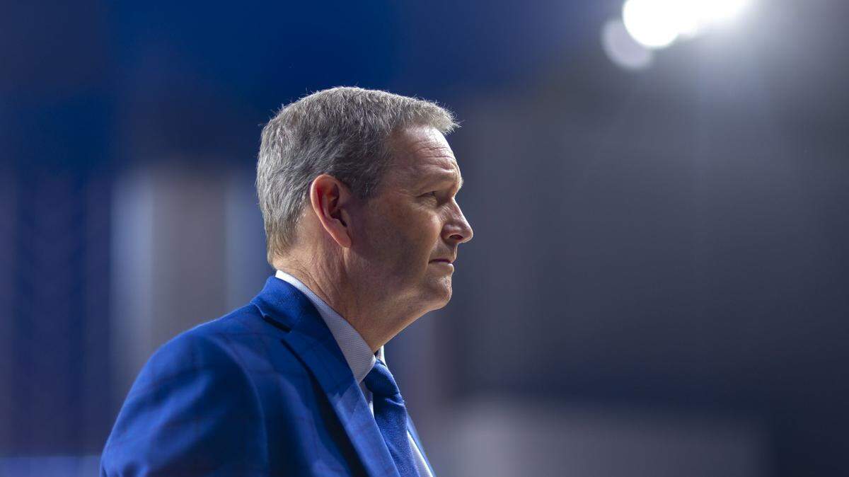 Mitch Barnart walks to a press conference on the court of Historic Memorial Coliseum in Lexington, Ky., to announce his retirement as University of Kentucky athletic director.  