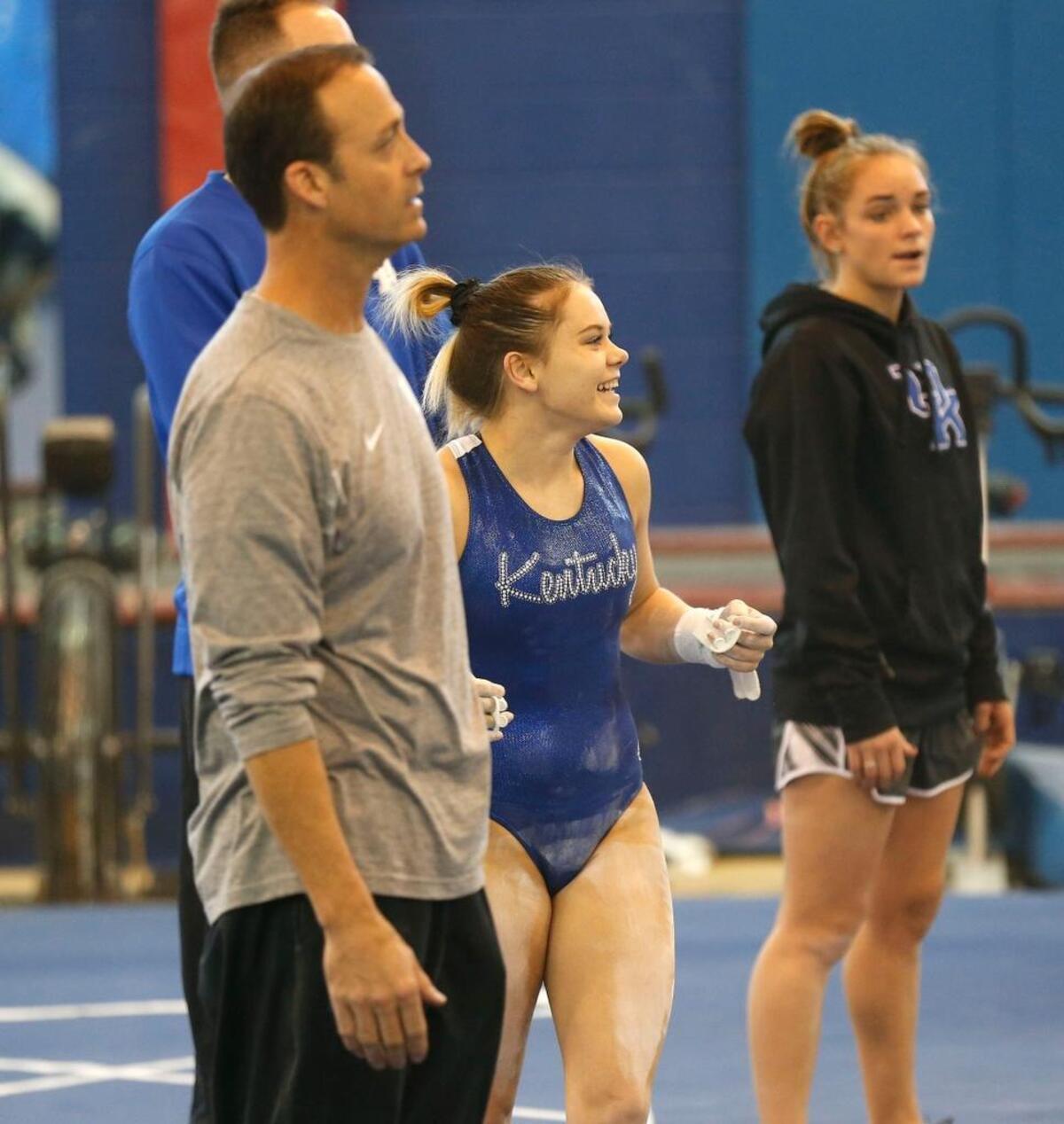 Freshman Ella Warren, with head coach Tim Garrison on the left, smiled during a University of Kentucky gymnastics practice held in the Nutter Fieldhouse Gymnastics Practice Facility on the UK campus in Lexington, Ky., Wednesday, Jan. 3, 2018. The team is coming off the most successful season in program history and will be holding Excite Night in Rupp Arena for first time.