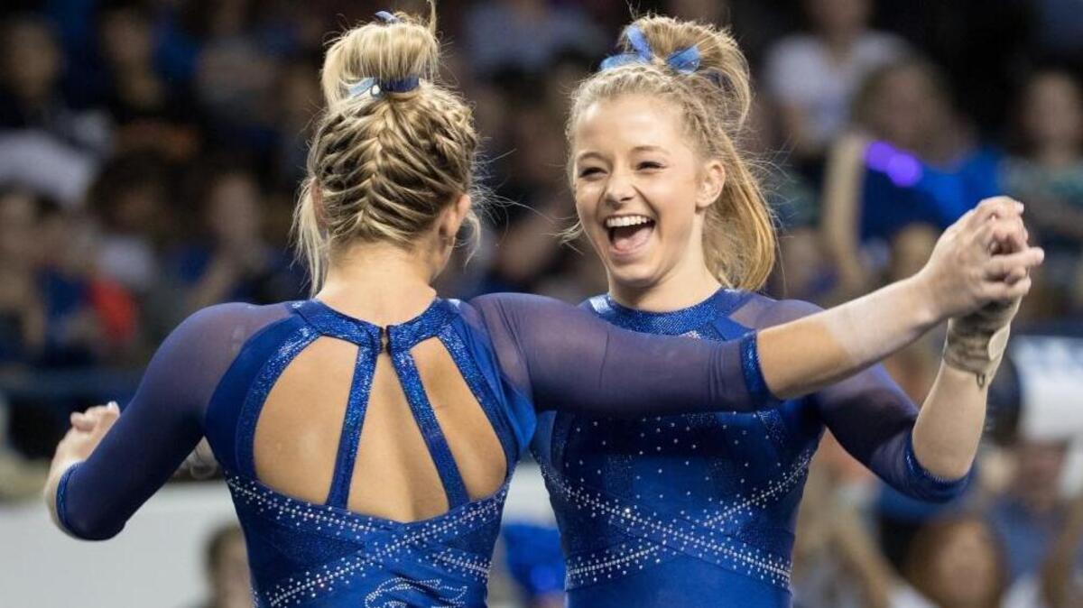 Kentucky’s Mollie Korth congratulated teammate Alex Hyland during last year’s Excite Night. This year’s event will be held in Rupp Arena.