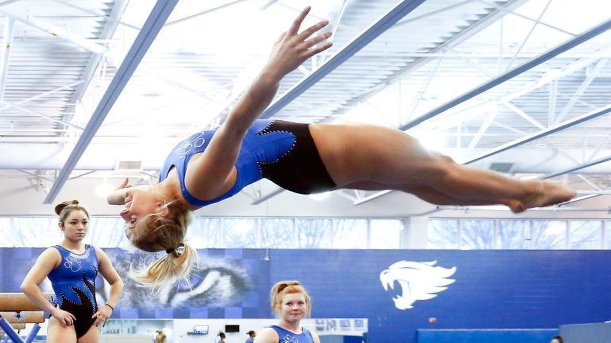 Alex Hyland spotted her landing as teammates Mollie Korth, Aubree Rosa and Sidney Dukes look on during the University of Kentucky Gymnastic team’s practice at their practice facility in the Nutter Field House on the UK campus in Lexington, Ky., Tuesday, January 17, 2017.
