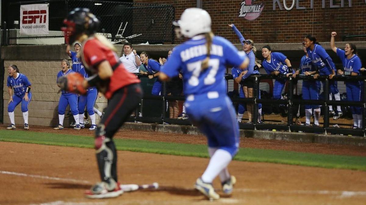 The University of Kentucky softball team celebrates as the Cats' Nikki Sagermann scores the go ahead run in the top of the 7th inning at Ulmer Stadium in Louisville, Ky., as UK beats Louisville 2-1.