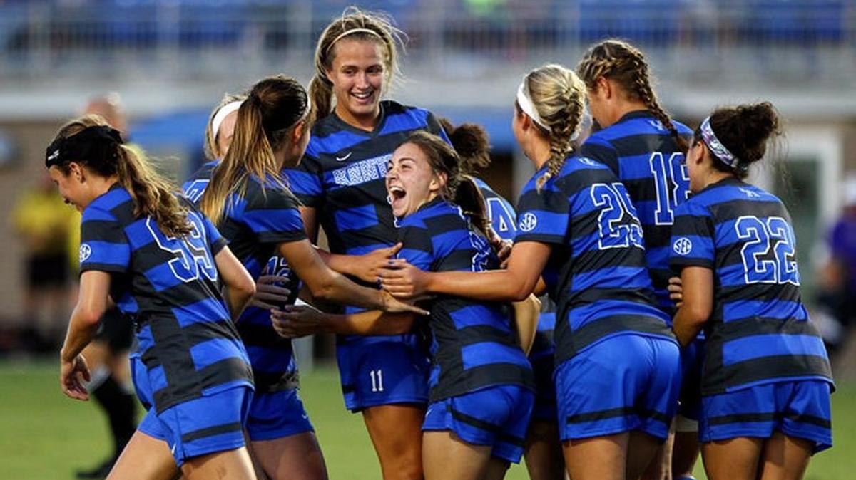Kentucky players hugged goal-scorer Courtney Raetzman, center, after her corner kick curved through traffic in the 39th minute for the game’s only score against Washington last August.