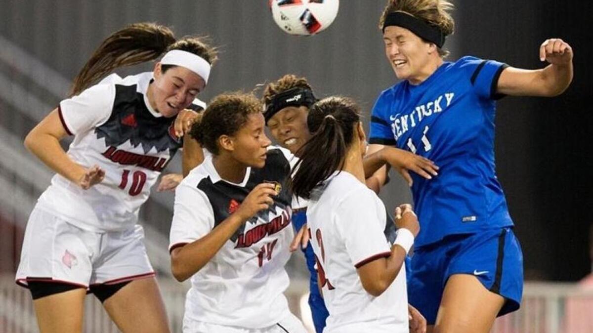 Kentucky’s Kaitlin Miller (11) took on a host of Cardinals on Friday night.