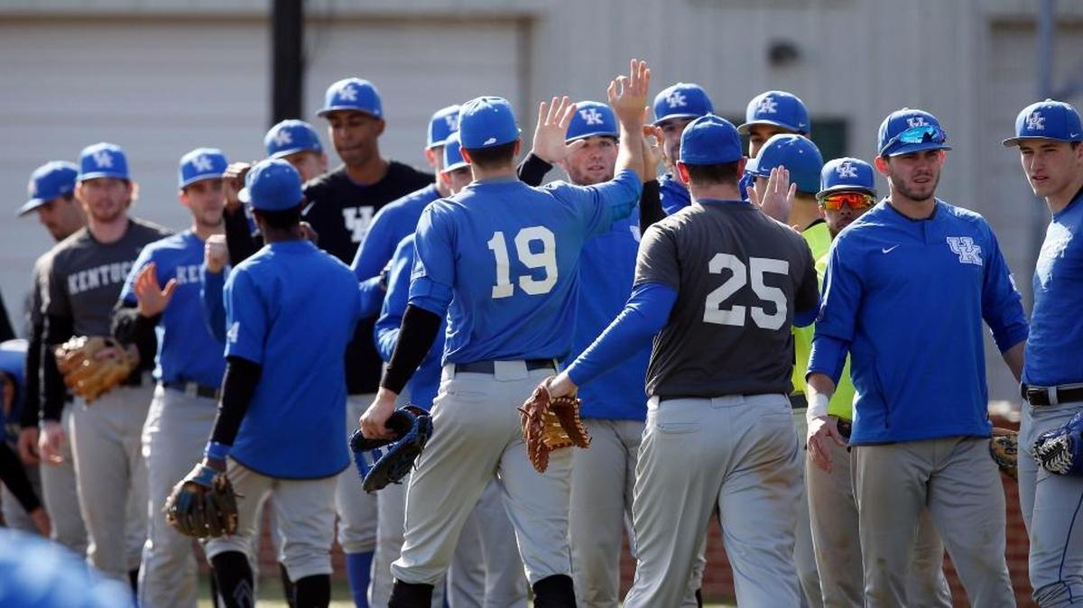 Kentucky infielder Evan White (19) and Kentucky first baseman Gunnar McNeill (25) high fives the team after infield as the University of Kentucky baseball team practiced and scrimmaged at Cliff Hagan Stadium on the UK campus in Lexington, Ky., Friday, February 10, 2017. This is Nick Mingione's first season as head coach of the baseball Wildcats.