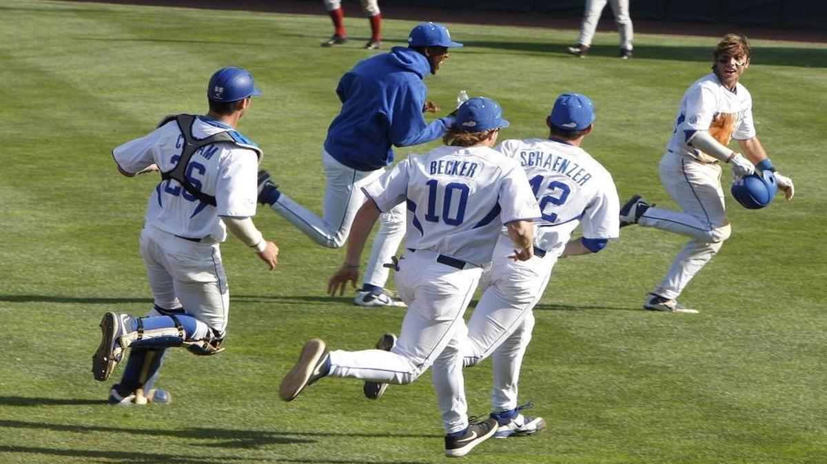 Teammates chased Troy Squires through the outfield following his game-winning RBI in the bottom of the seventh inning as UK defeated Arkansas in the second game of a doubleheader at Cliff Hagan Stadium in Lexington on Saturday, April 23, 2016.