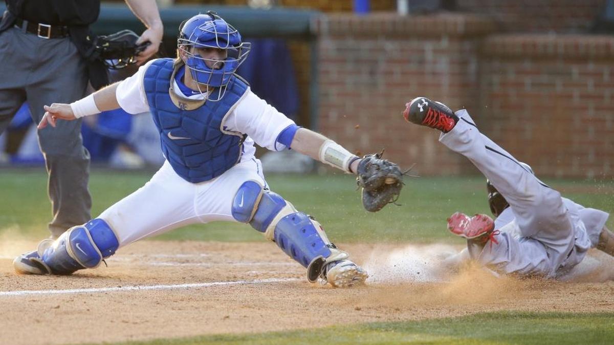 Cincinnati infielder Manny Rodriguez scored out of the reach of Kentucky catcher Troy Squires as Kentucky defeated Cincinnati 8-4 on March 8, 2016 in Lexington, Ky.