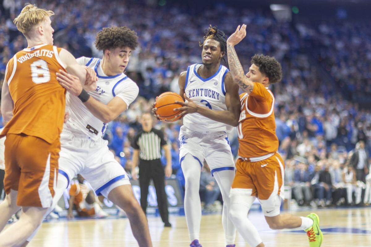 Kentucky basketball guard Kam Williams (3) drives the ball as Texas guard Jordan Pope (0) defends during a game at Rupp Arena in Lexington, Ky., on Wednesday, Jan. 21, 2026.  