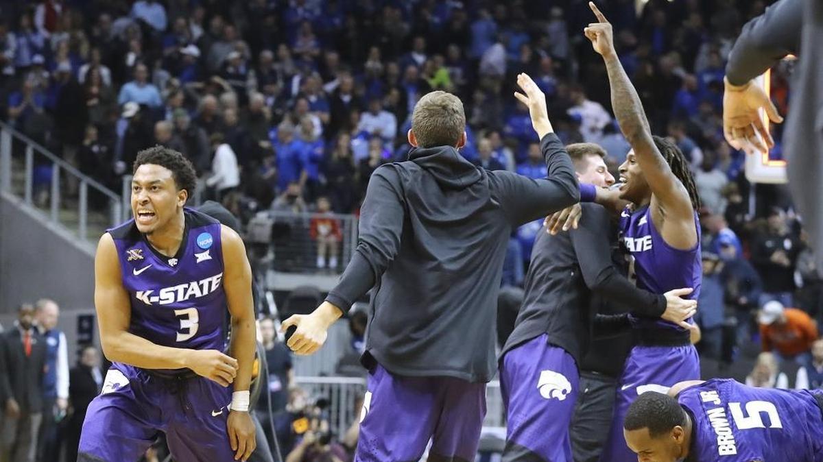Kansas State guard Kamau Stokes and teammates celebrate after defeating Kentucky 61-58 in an NCAA men's college basketball tournament regional semifinal early Friday, March 23, 2018, in Atlanta.