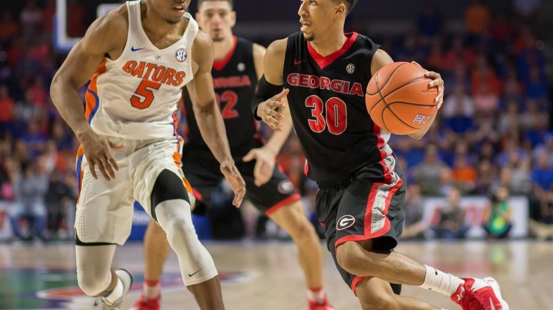 Georgia guard J.J. Frazier (30) drives past Florida guard KeVaughn Allen (5) during the second half of an NCAA college basketball game in Gainesville, Fla., Saturday, Jan. 14, 2017. Florida won in overtime 80-76.