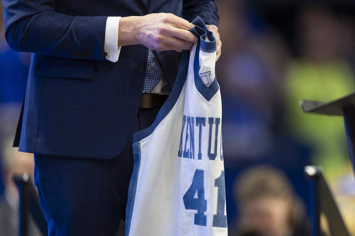 Mark Pope holds his denim jersey from the 1995-96 season during his introduction as Kentucky’s new head coach in Rupp Arena in April 2024.