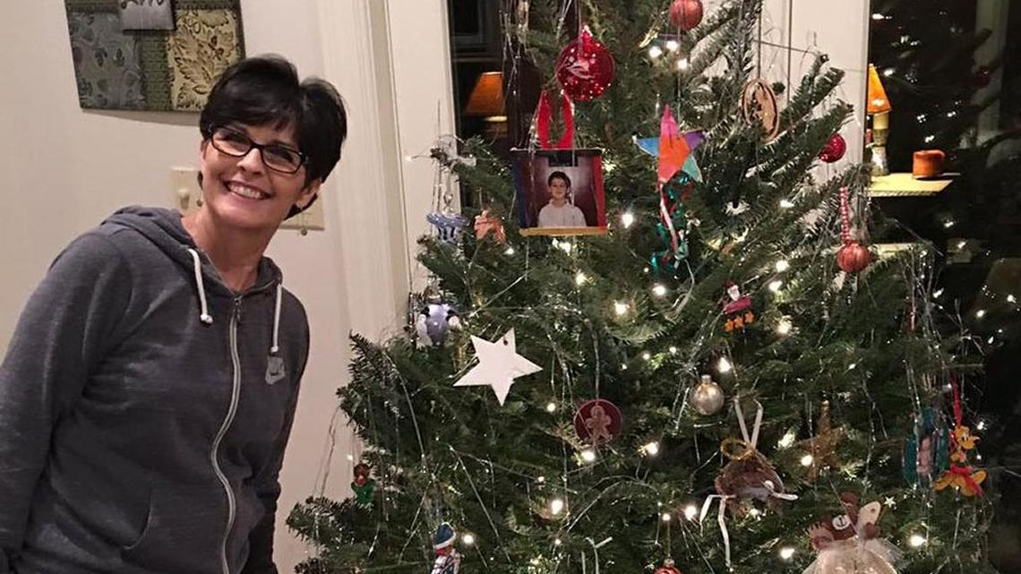 John Calipari’s wife, Ellen, posed with the family’s decorated Christmas tree in a picture the Kentucky basketball coach posted on Twitter.
