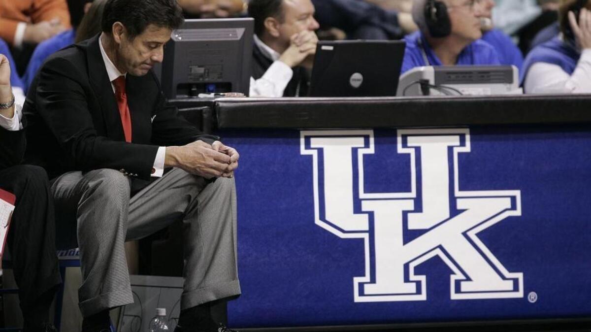 Louisville head coach Rick Pitino sat dejected at the end of the bench near the finish of a Cardinals loss to Kentucky in Rupp Arena in 2005.