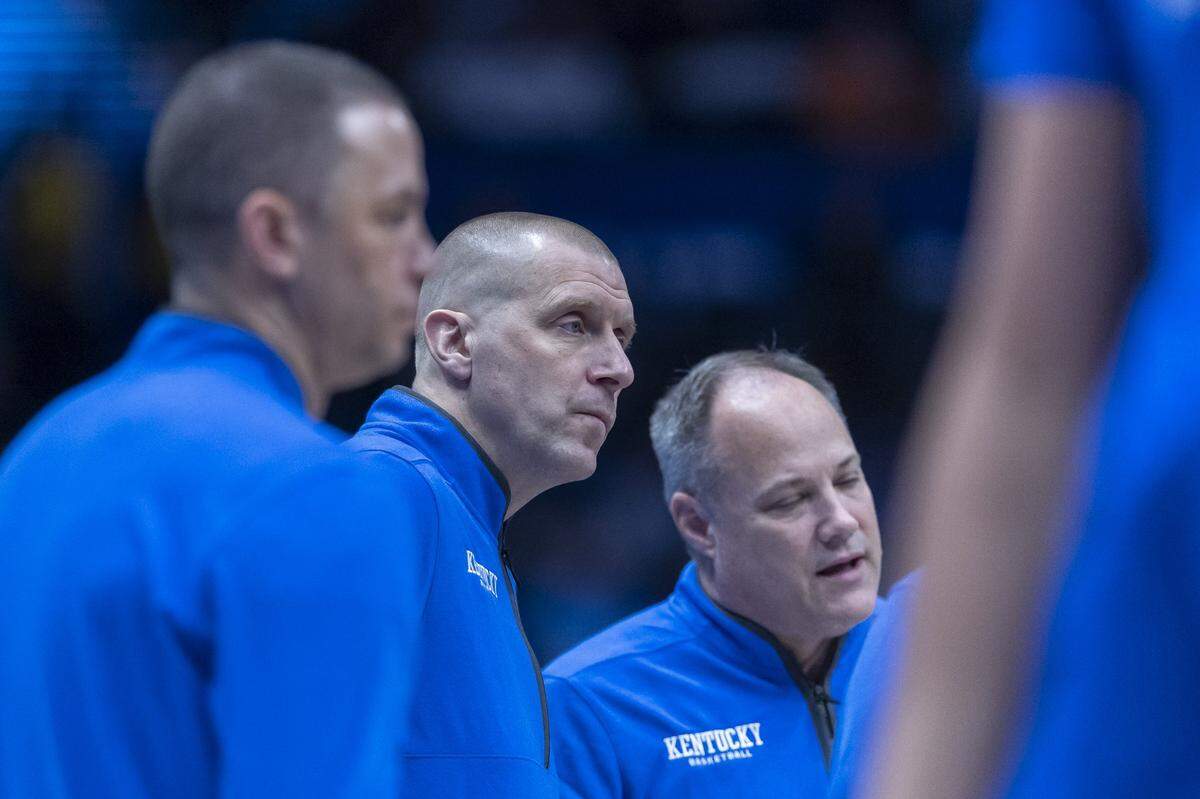 Kentucky head coach Mark Pope, center, huddles with director of basketball operations Nick Robinson, left, assistant Mark Fox, right, and other coaches during this year’s SEC Tournament.