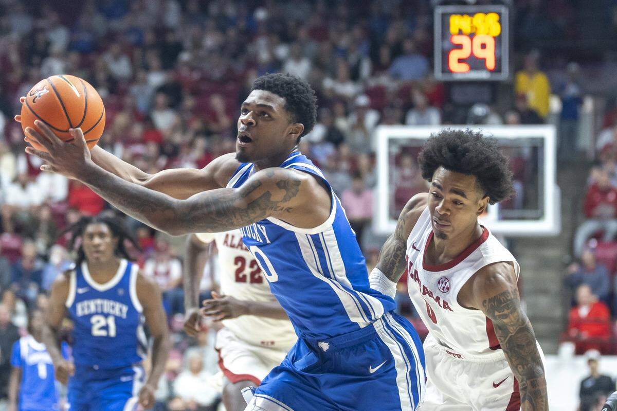 Kentucky Wildcats guard Otega Oweh (00) drives the ball in front of Alabama Crimson Tide guard Labaron Philon (0) during a game at Coleman Coliseum in Tuscaloosa, Alabama, on Saturday.  