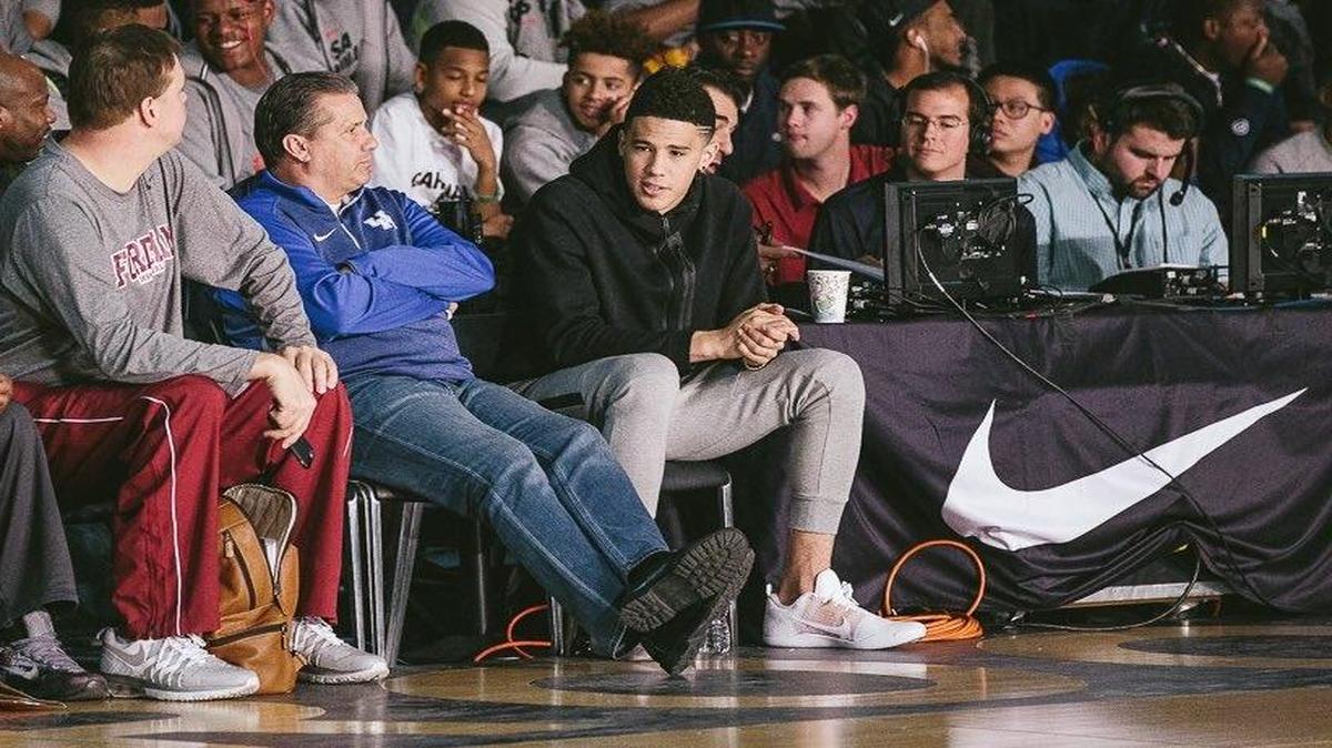 UK Coach John Calipari was joined courtside at Saturday’s Nike event in Brooklyn by former Wildcats guard Devin Booker, who just completed his rookie season with the Phoenix Suns. Booker played on the Nike circuit two years ago.