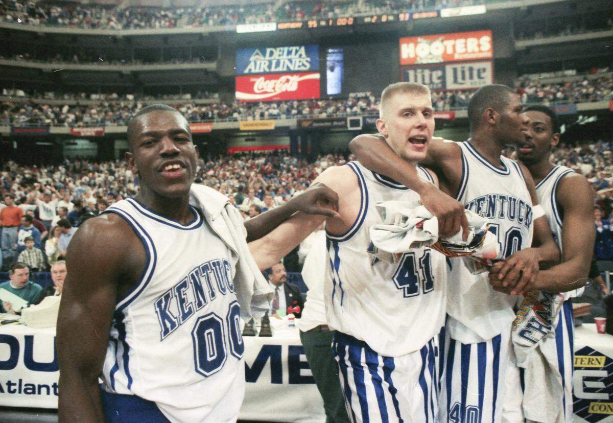 From left, Kentucky's Tony Delk, Mark Pope, Walter McCarty and Andre Riddick, celebrated in their “icicle” shorts after UK defeated Arkansas in overtime to win the 1995 SEC Tournament title game.