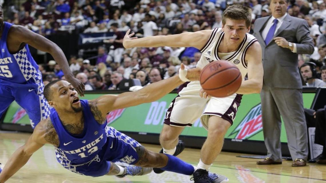 Kentucky guard Isaiah Briscoe (13) swatted the ball to a teammate as he fell and Texas A&M guard Chris Collins (12) chased it in the second half.