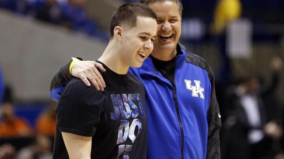 UK Coach John Calipari hugged his son Brad during the team’s open practice in Lucas Oil Stadium in Indianapolis during the 2014 NCAA Tournament.