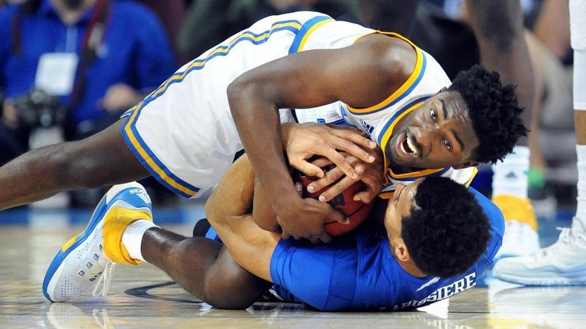 UCLA guard Isaac Hamilton, top, battled for a loose ball with Kentucky forward Skal Labissiere on Thursday. UCLA won, 87-77.
