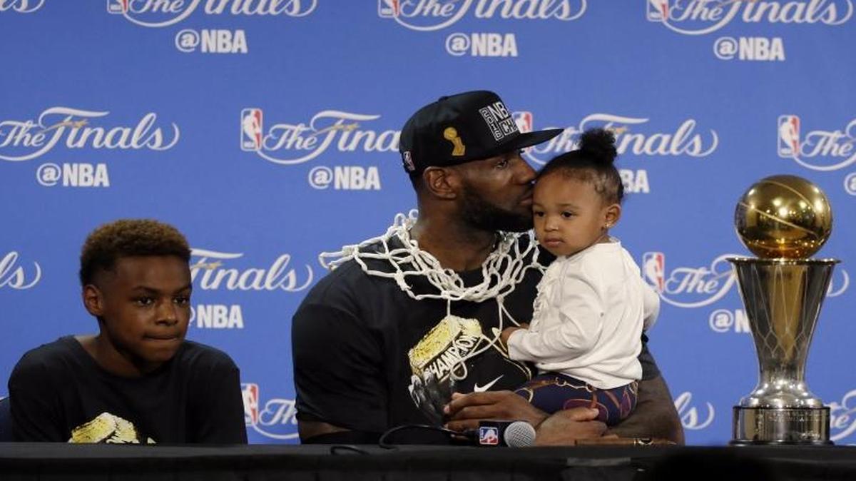 Cleveland Cavaliers star LeBron James, center, sits down to answer questions alongside his family during a post-game press conference after Game 7 of the NBA Finals on Sunday.