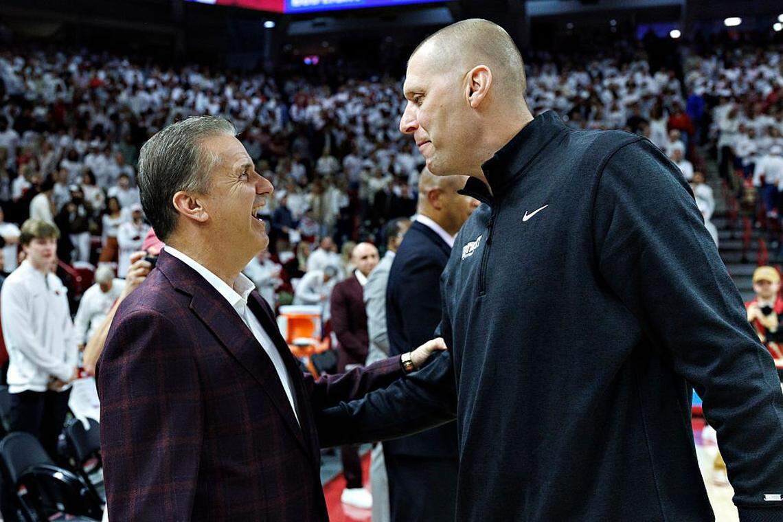 Kentucky coach Mark Pope, right, and former UK and current Arkansas head man John Calipari, left, greeted each other prior to what became the Wildcats’ 85-77 win over the Razorbacks this season at Bud Walton Arena in Fayetteville, Arkansas.