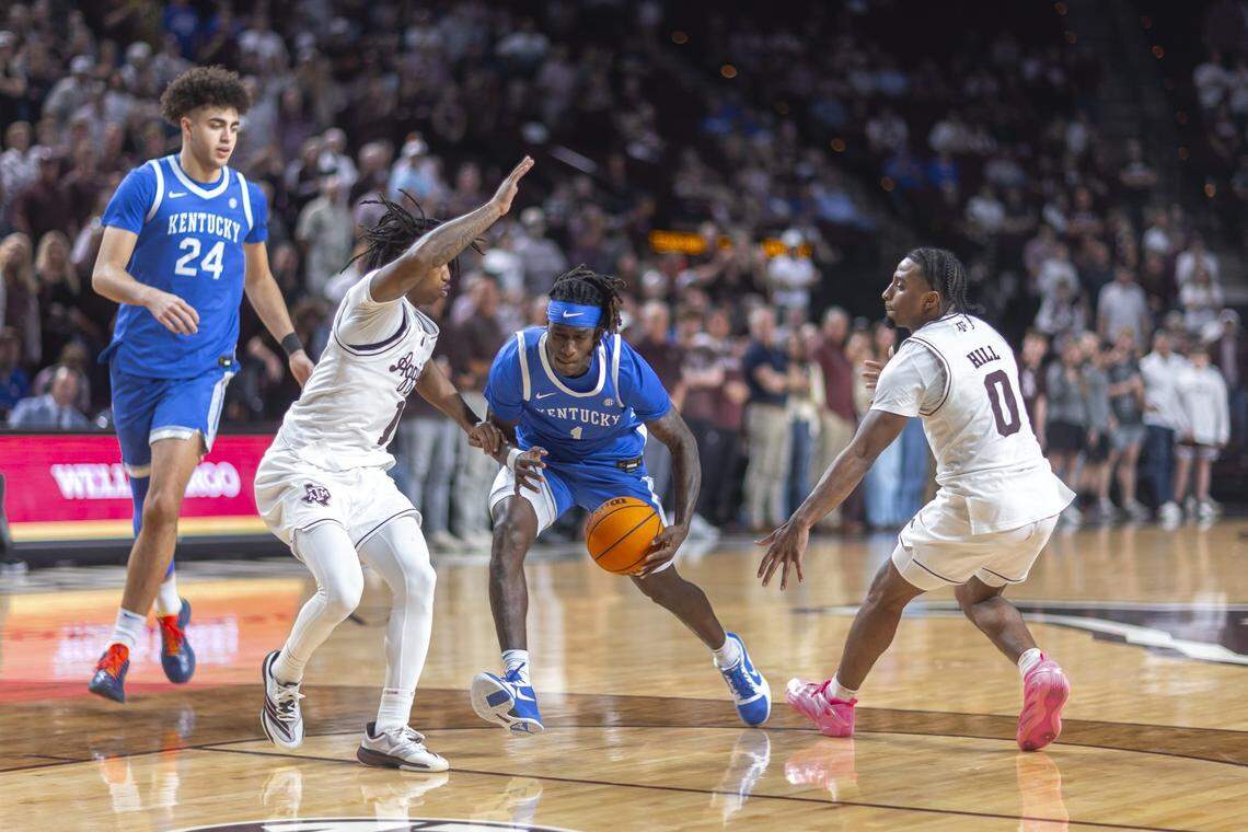 Kentucky basketball guard Denzel Aberdeen (1) drives the ball as Texas A&M guard Josh Holloway (1) defends during a game at Reed Arena in College Station, Texas, on Tuesday. 