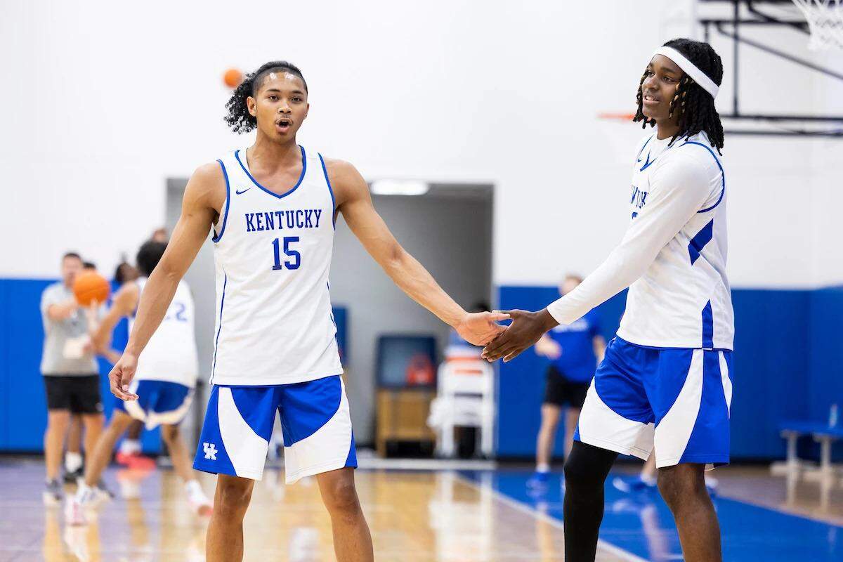 Kentucky guard Jaland Lowe, left, slaps hands with teammate Jasper Johnson during one of the Wildcats’ offseason workouts.