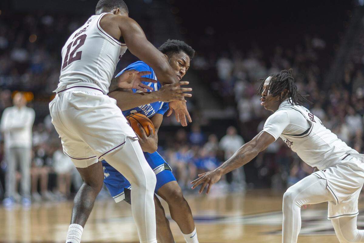 Kentucky basketball forward Mo Dioubate (23) is pressured by Texas A&M forward Rashaun Agee (12) and Texas A&M guard Josh Holloway (1) during a game at Reed Arena in College Station, Texas, on Tuesday. 
