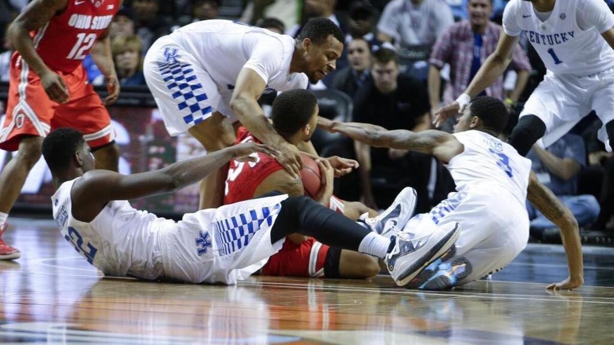 Ohio State Buckeyes forward Marc Loving (2) wins the loose ball amongst Kentucky Wildcats guard Isaiah Briscoe (13) , Ulis, 3, and Poythress, 22, as Kentucky falls to Ohio State 74-67 on Saturday Dec. 19, 2015 in Brooklyn, N.Y.