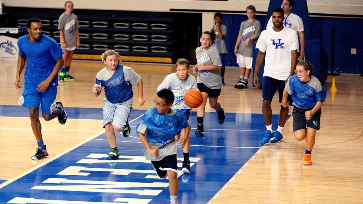 Aaron Wyckoff, 11, of Plainfield, IL drives down court during a scrimmage that included E. J. Floreal and Andrew Harrison during UK coach John Calipari's Pro Camp at the Joe Craft Center in Lexington, Ky., Saturday, August 1, 2015.