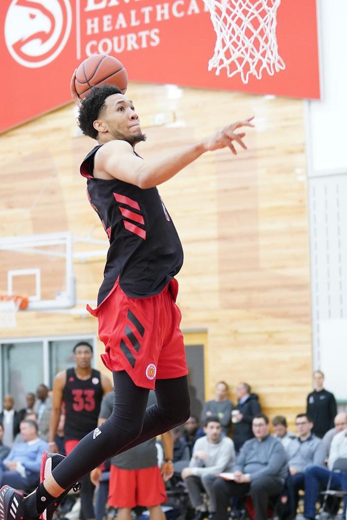 EJ Montgomery goes in for a dunk at practice this week.