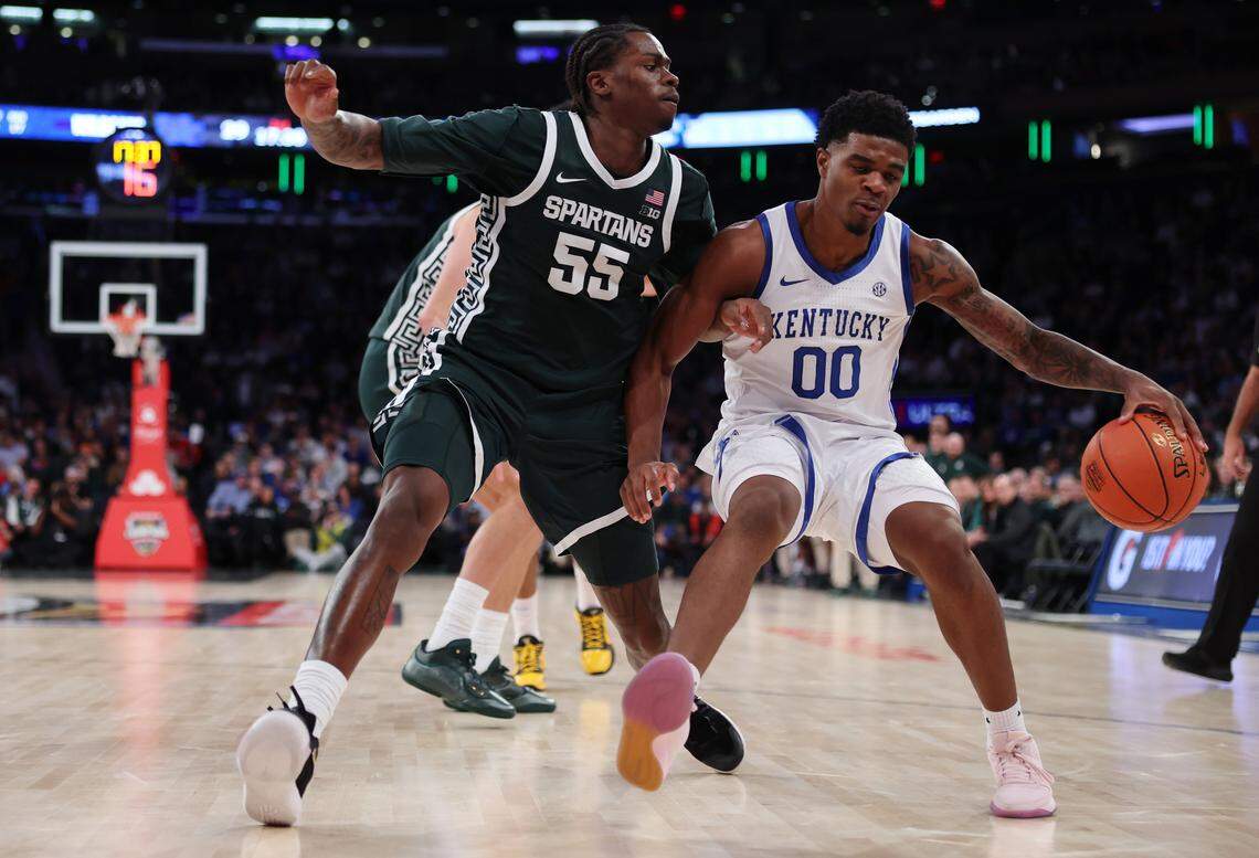 Otega Oweh attempts to dribble past Michigan State’s Coen Carr during Kentucky’s 83-66 loss to the Spartans in New York on Nov. 18.