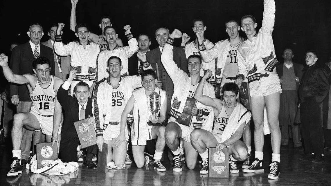 Bobby Watson, center of front row holding trophy, celebrated Kentucky’s 1951 NCAA championship with his teammates. Other players include, front row: Lou Tsioropoulos, C.M. Newton, Cliff Hagan, Lucian Whitaker and Frank Ramsey. Back row: Dwight Price, Bill Spivey, Guy Strong, Roger Layne and Shelby Linville.