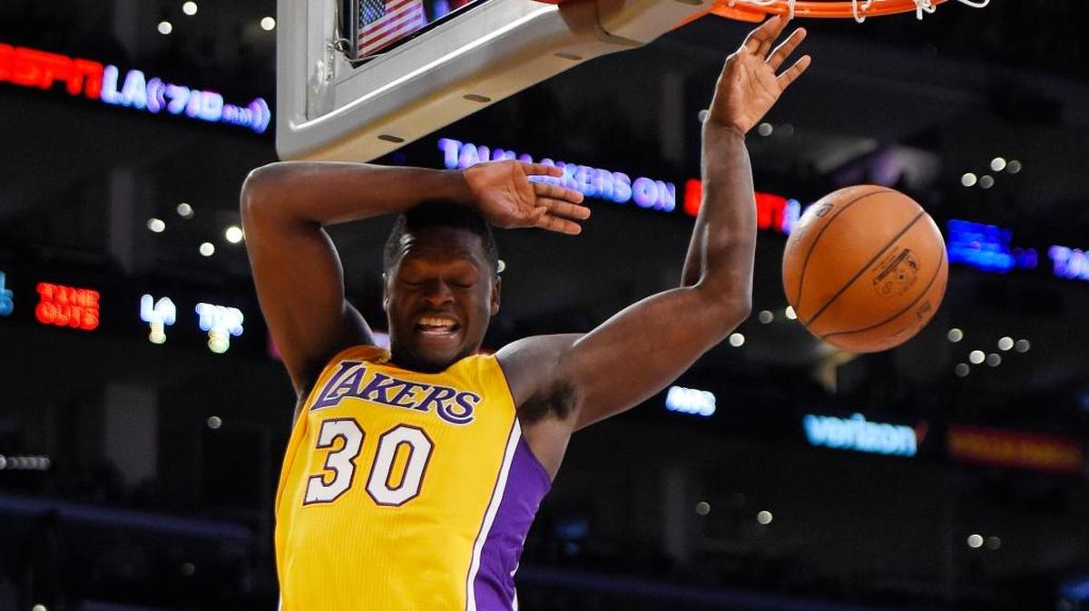 Los Angeles Lakers forward Julius Randle dunks during the second half of an NBA basketball game against the Toronto Raptors, Friday, Nov. 20, 2015, in Los Angeles. The Raptors won 102-91.