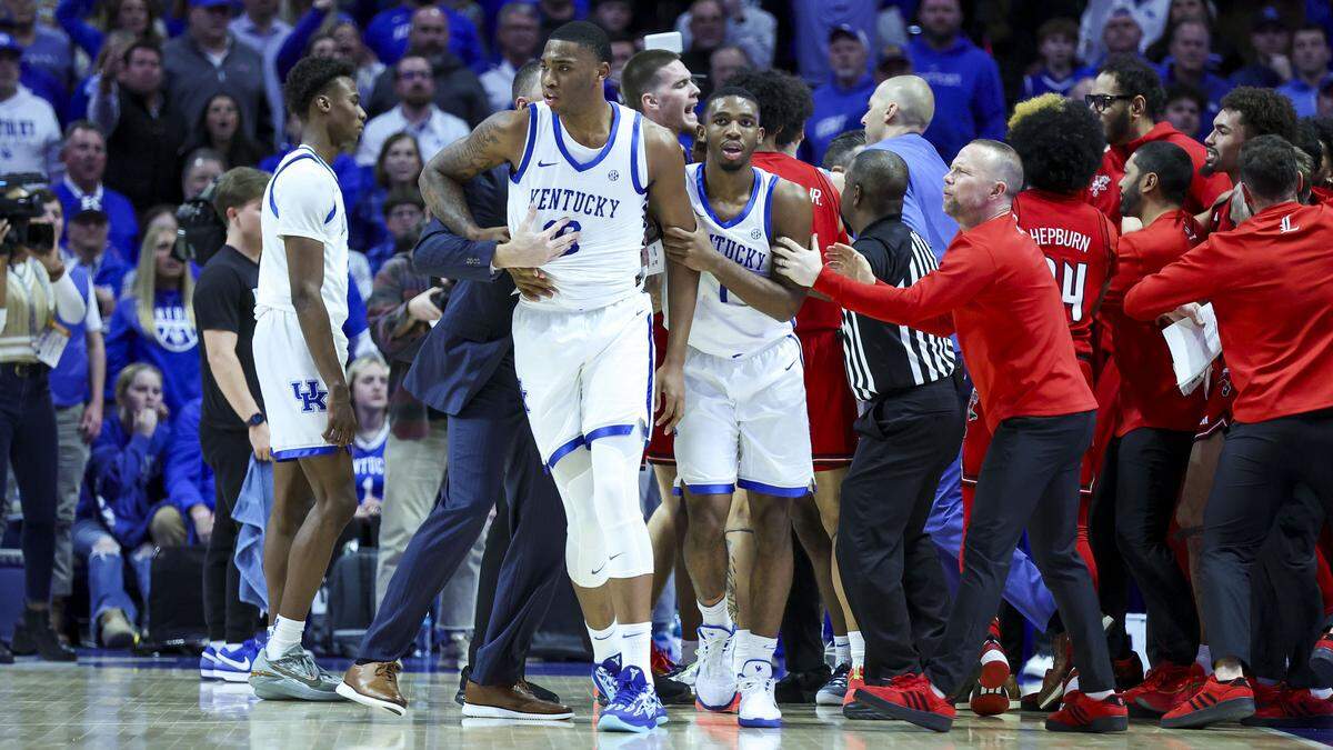 Louisville head coach Pat Kelsey, right, and Kentucky head coach Mark Pope, back, helped break up a scrum during UK’s 93-85 win over U of L last season at Rupp Arena.