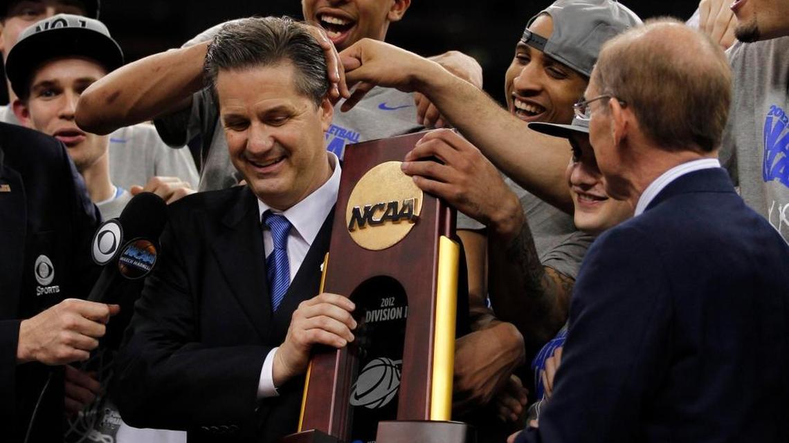 UK team and head coach John Calipari of the Kentucky Wildcats with the trophy after defeating Kansas in the championship game of the NCAA Final Four basketball tournament Monday, April 2, 2012, in New Orleans.