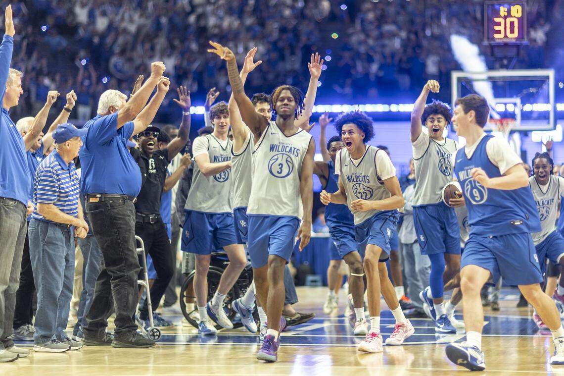 Kentucky guard Kam Williams hits a halfcourt shot to end Big Blue Madness as current and former UK players cheer him on in Rupp Arena on Saturday night.