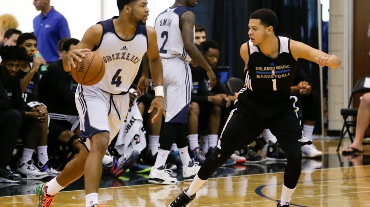 The Memphis Grizzlies’ Andrew Harrison moved the ball around Orlando Magic Blue’s Tyler Harvey (1) during Summer League play last year.