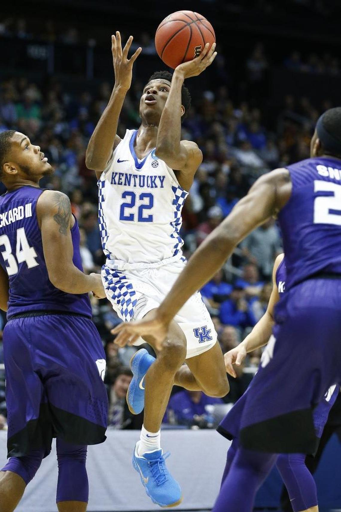 Kentucky Wildcats guard Shai Gilgeous-Alexander (22) shot between Kansas State Wildcats forward Levi Stockard III (34) and Kansas State Wildcats forward Xavier Sneed (20) during their Sweet 16 game Thursday at Philips Arena in Atlanta.