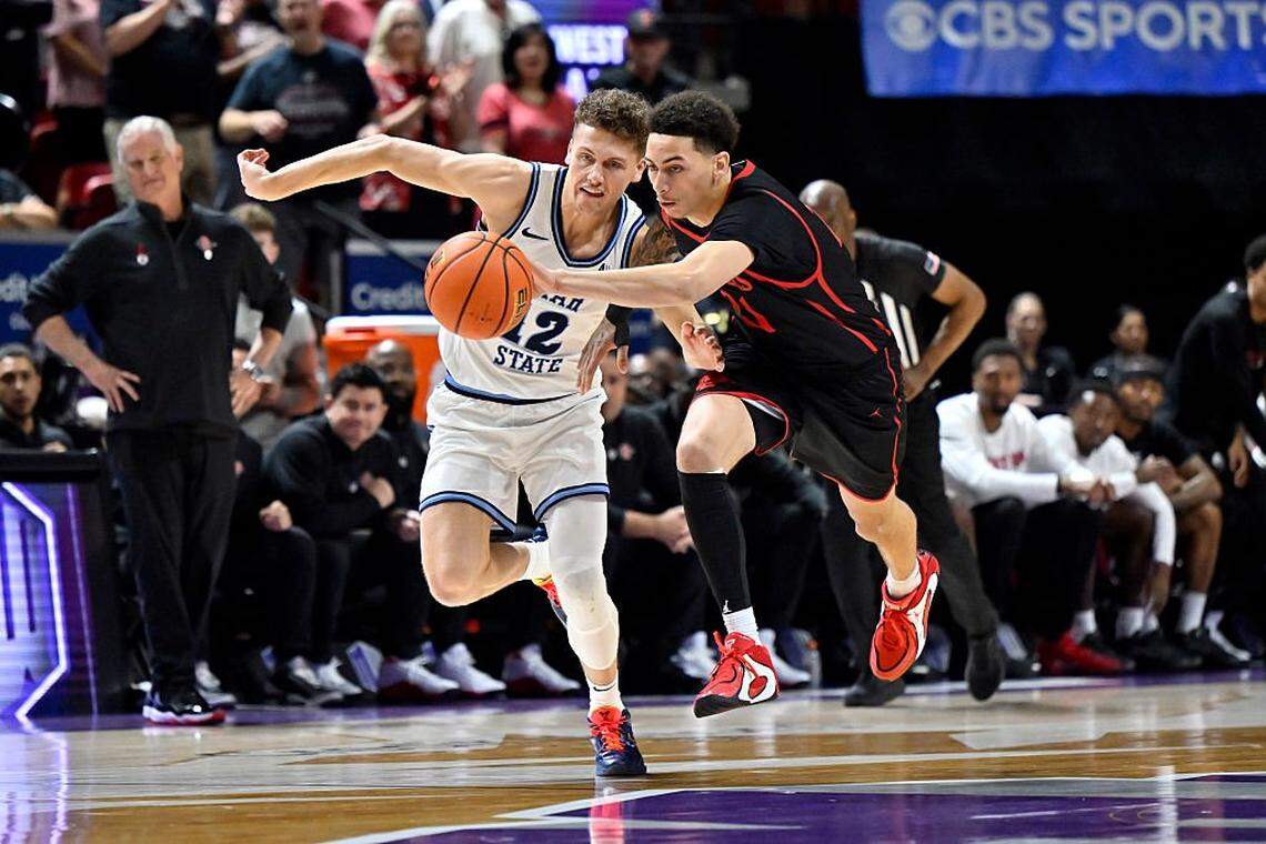 Miles Byrd, right, battles for a loose ball in a game against Utah State earlier this month. Byrd will transfer from San Diego State for his final season of college basketball.