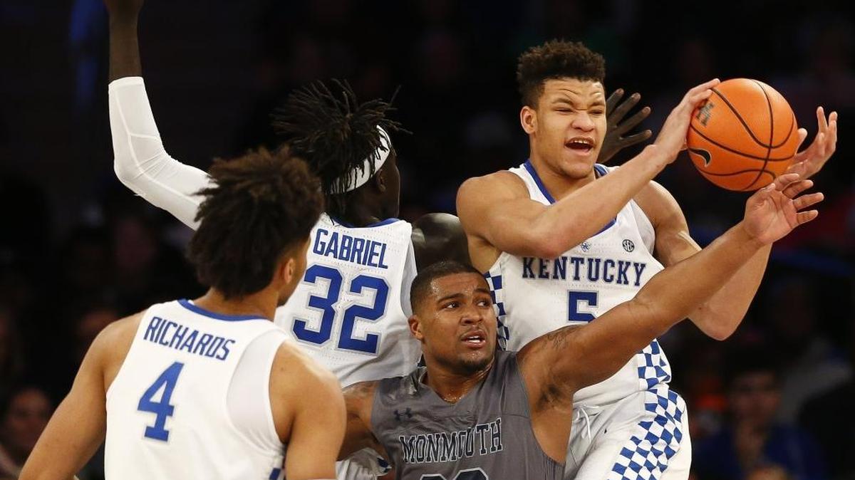 Kentucky forward Kevin Knox (5) rebounds the ball over Monmouth guard Austin Tilghman (23) during the Citi Hoops Classic at Madison Square Garden in New York, Saturday, Dec. 9, 2017. Knox went 1-for-9 from the field and committed seven turnovers in Kentucky’s 93-76 win against Monmouth.