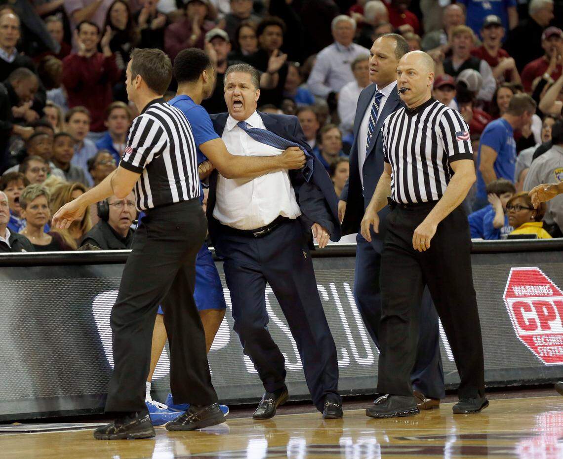 Referee Doug Sirmons, left, ejected Kentucky head coach John Calipari, who was being held by Wildcats guard Jamal Murray, early in a game against South Carolina on Feb. 13, 2016.