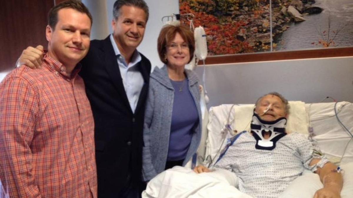 Dick Gregory, right, got a visit at the hospital on Nov. 5, 2013, from Kentucky Coach John Calipari, second from left, and his Cats. “He was buoyed,” son Scott, left, said of his dad. Gregory’s wife, Mary Alice, also was at his bedside. Gregory was severely injured in a fall at Rupp Arena the Friday before.